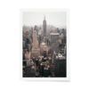 Fine art photograph of the New York City skyline with the Empire State Building centered on a hazy day, featuring warm, muted city tones.