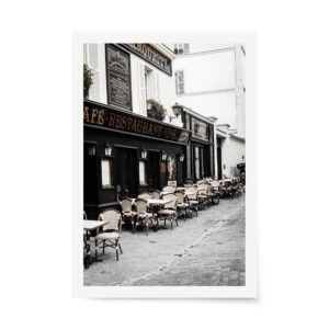 Classic Parisian café with vintage signage and rows of bistro chairs lining a cobblestone street in Montmartre.